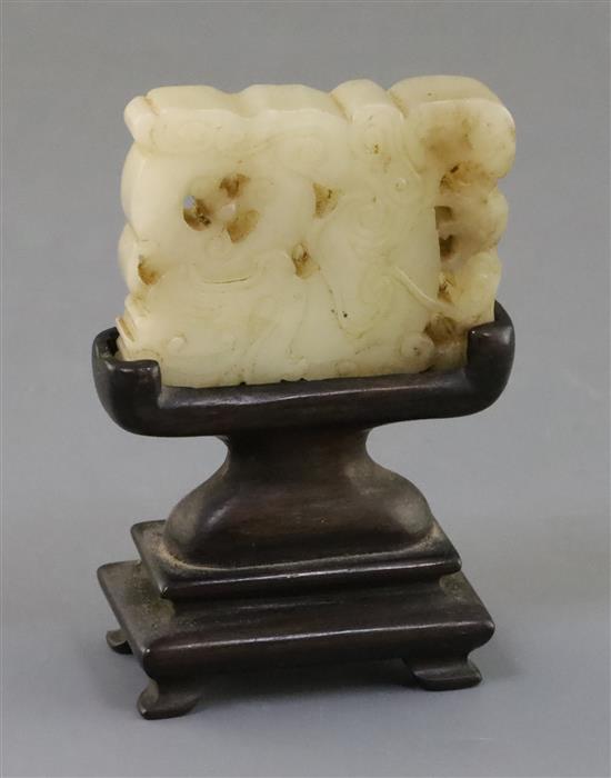 A Chinese archaistic pale celadon jade plaque, 17th/18th century, 5cm, wood stand